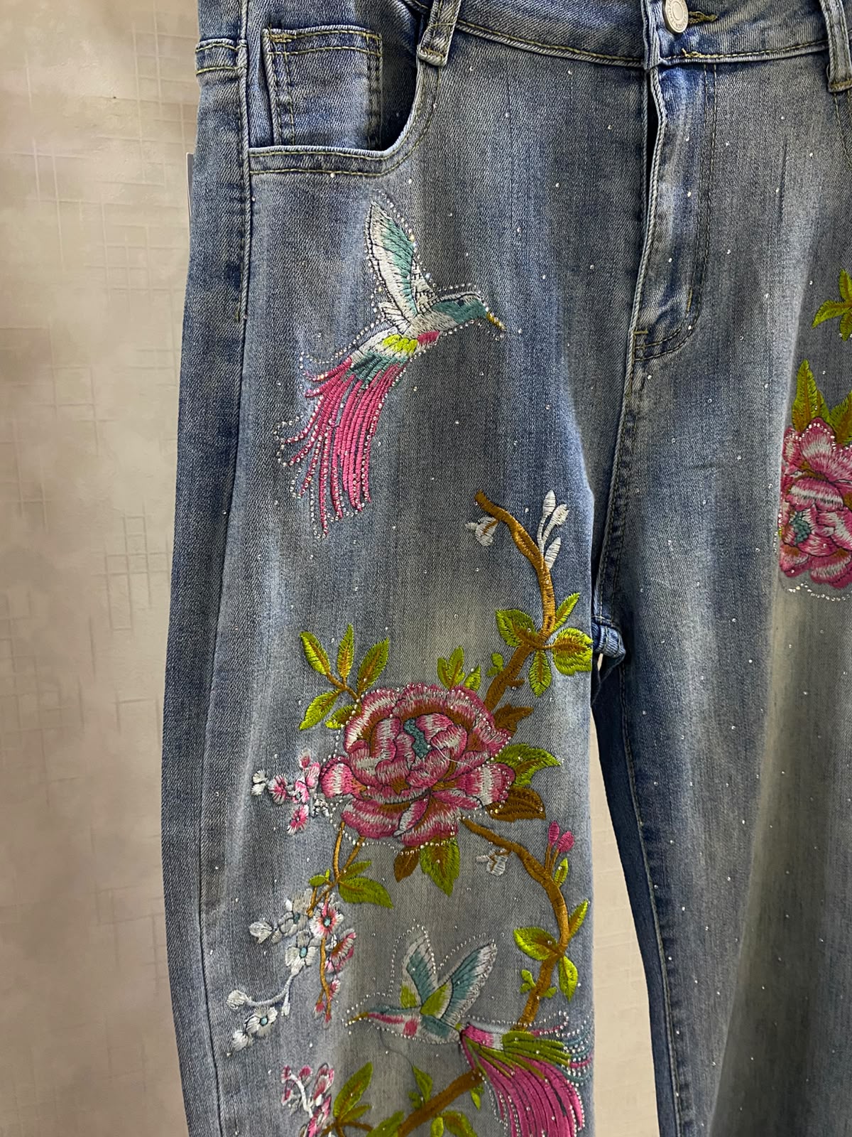 Beautiful wide-leg denim jeans accented with vibrant pink floral embroidery and subtle sparkling embellishments FT950