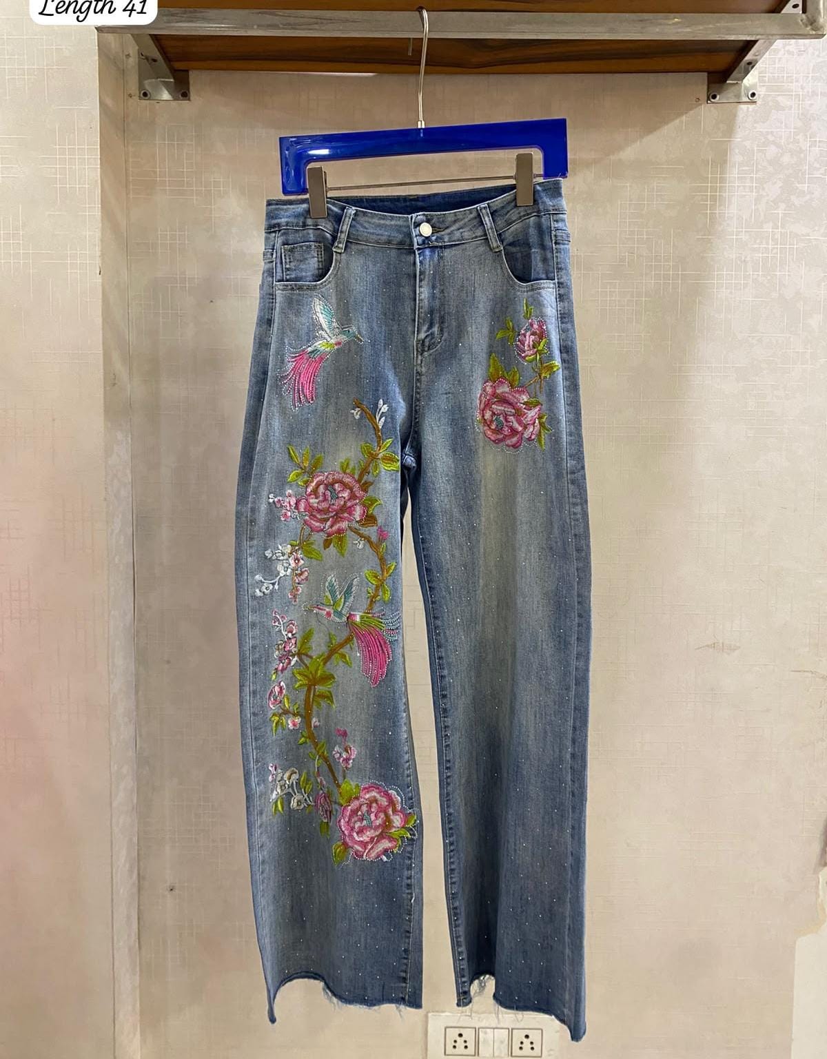 Beautiful wide-leg denim jeans accented with vibrant pink floral embroidery and subtle sparkling embellishments FT950