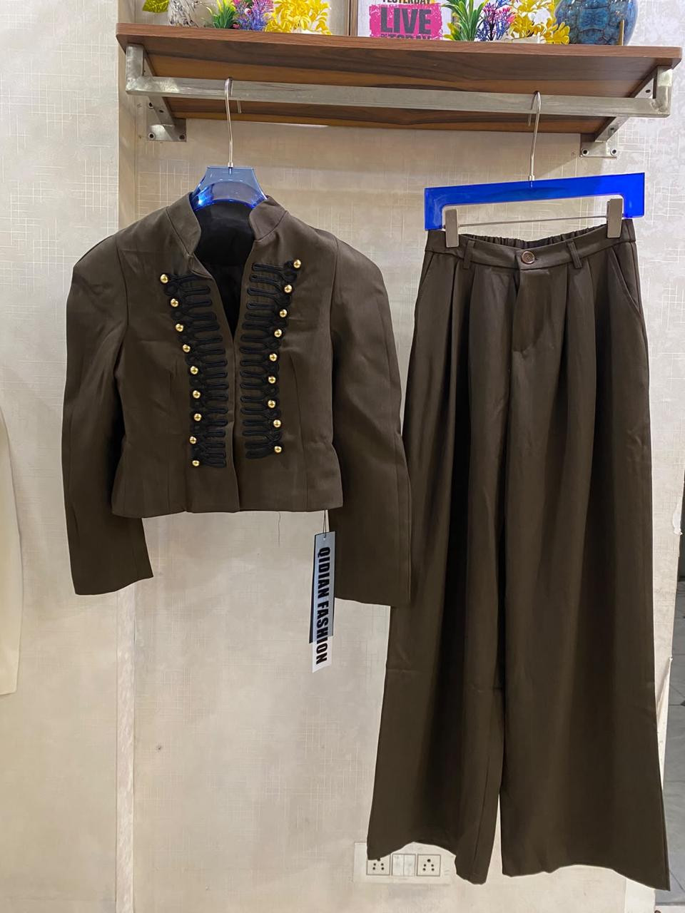 Elegant  off-white two-piece set with a military-inspired cropped jacket accented by black braiding and metallic buttons FT954