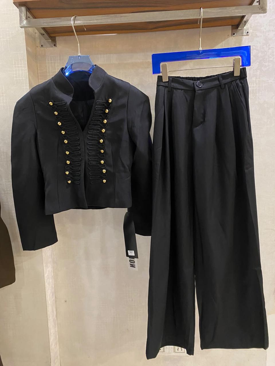 Elegant  off-white two-piece set with a military-inspired cropped jacket accented by black braiding and metallic buttons FT954