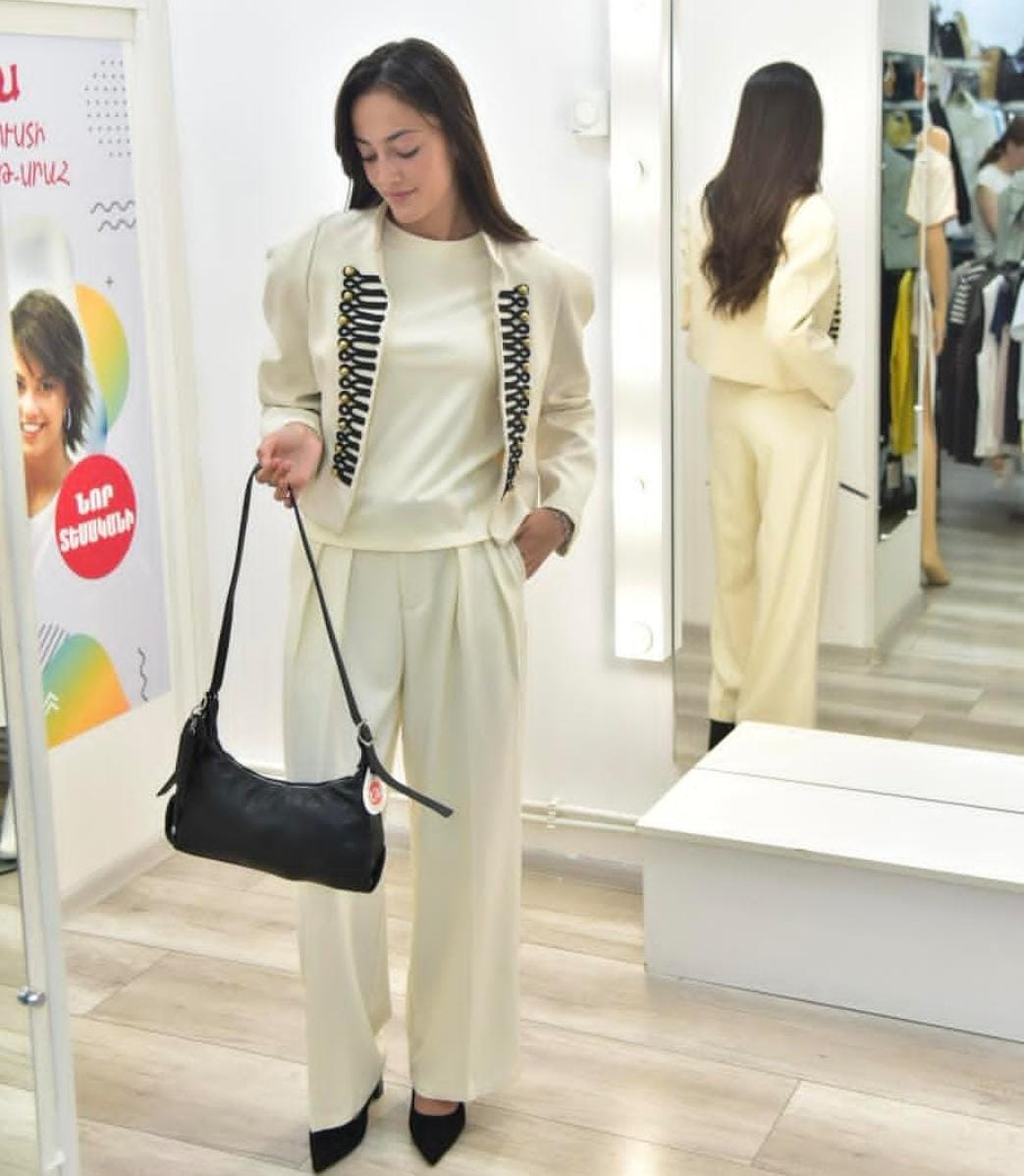 Elegant  off-white two-piece set with a military-inspired cropped jacket accented by black braiding and metallic buttons FT954