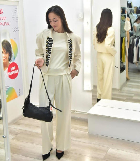 Elegant  off-white two-piece set with a military-inspired cropped jacket accented by black braiding and metallic buttons FT954