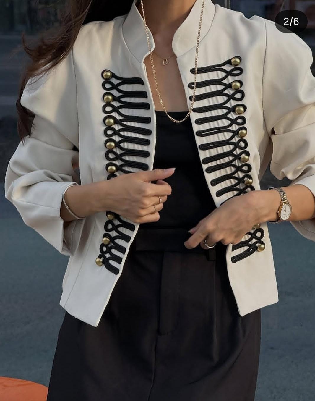 Elegant  off-white two-piece set with a military-inspired cropped jacket accented by black braiding and metallic buttons FT954